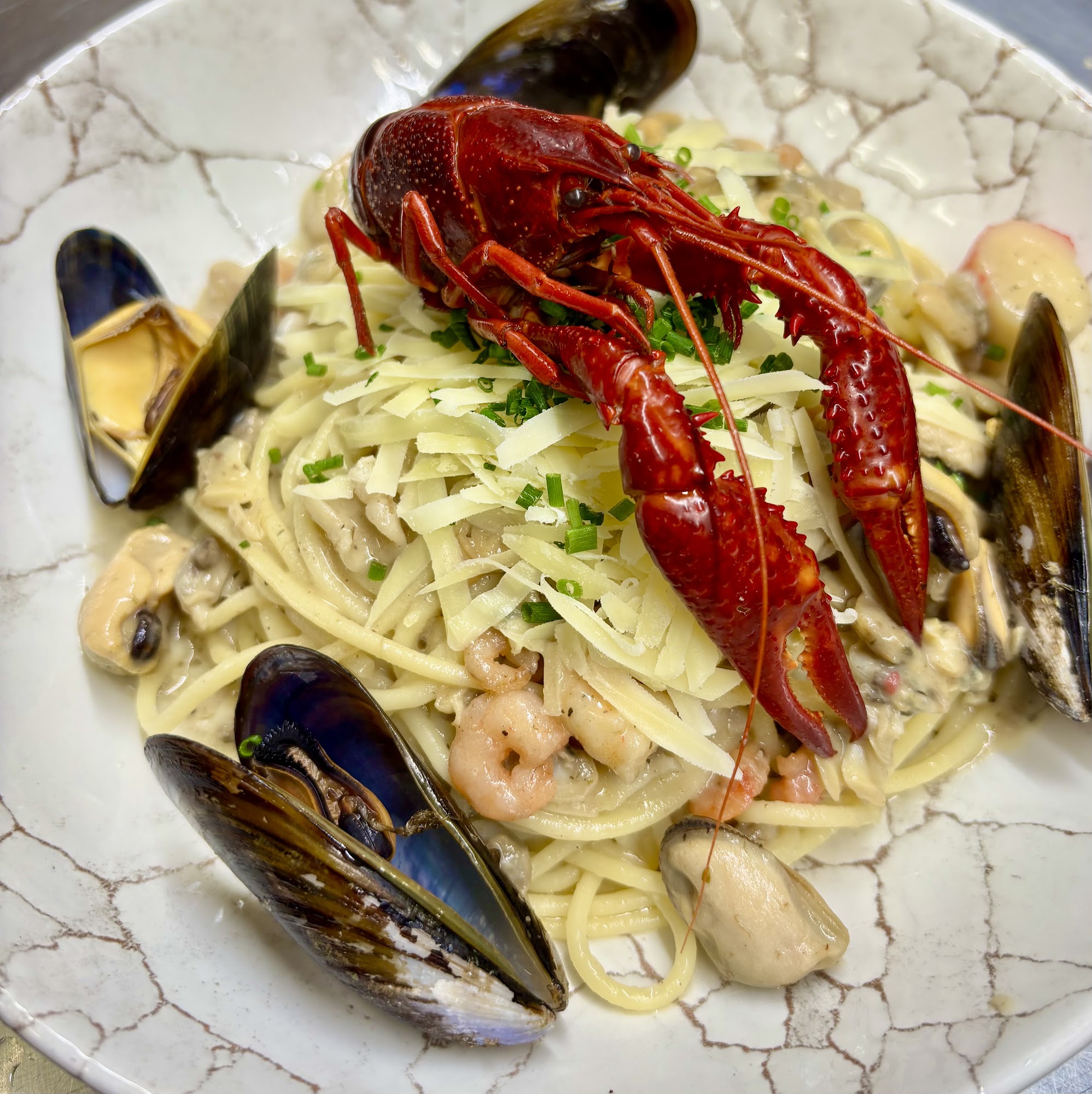 Seafood pasta presented at Café Derbl